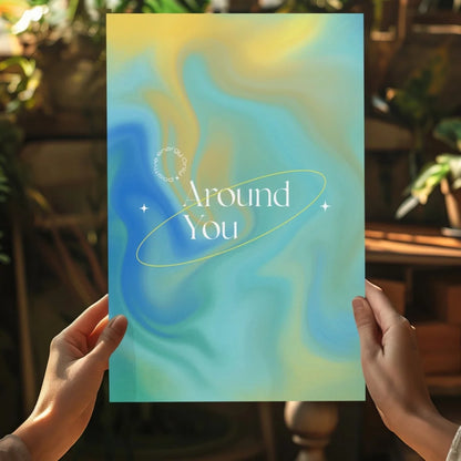 Insigne aluminum print of teal-yellow gradient with Around You in gold oval