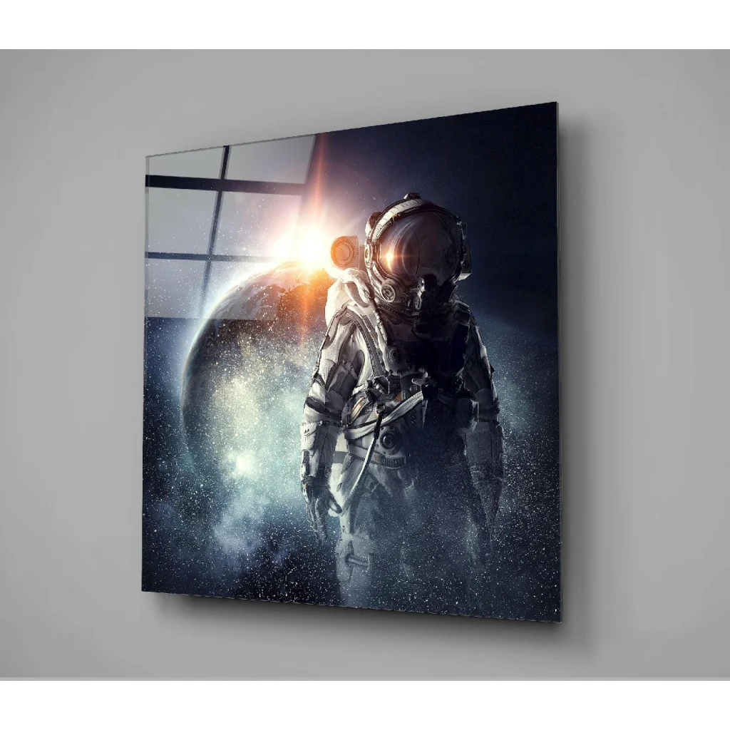 Detailed astronaut in silver spacesuit before glowing planet on glass wall art