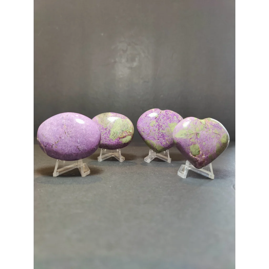 Polished heart-shaped and palmstone sculptures in purple and green made of atlantisite stichtite and serpentine