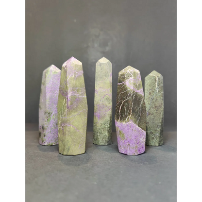Five polished green and purple atlantisite tower sculptures with natural veining in a polished tower sculpture set