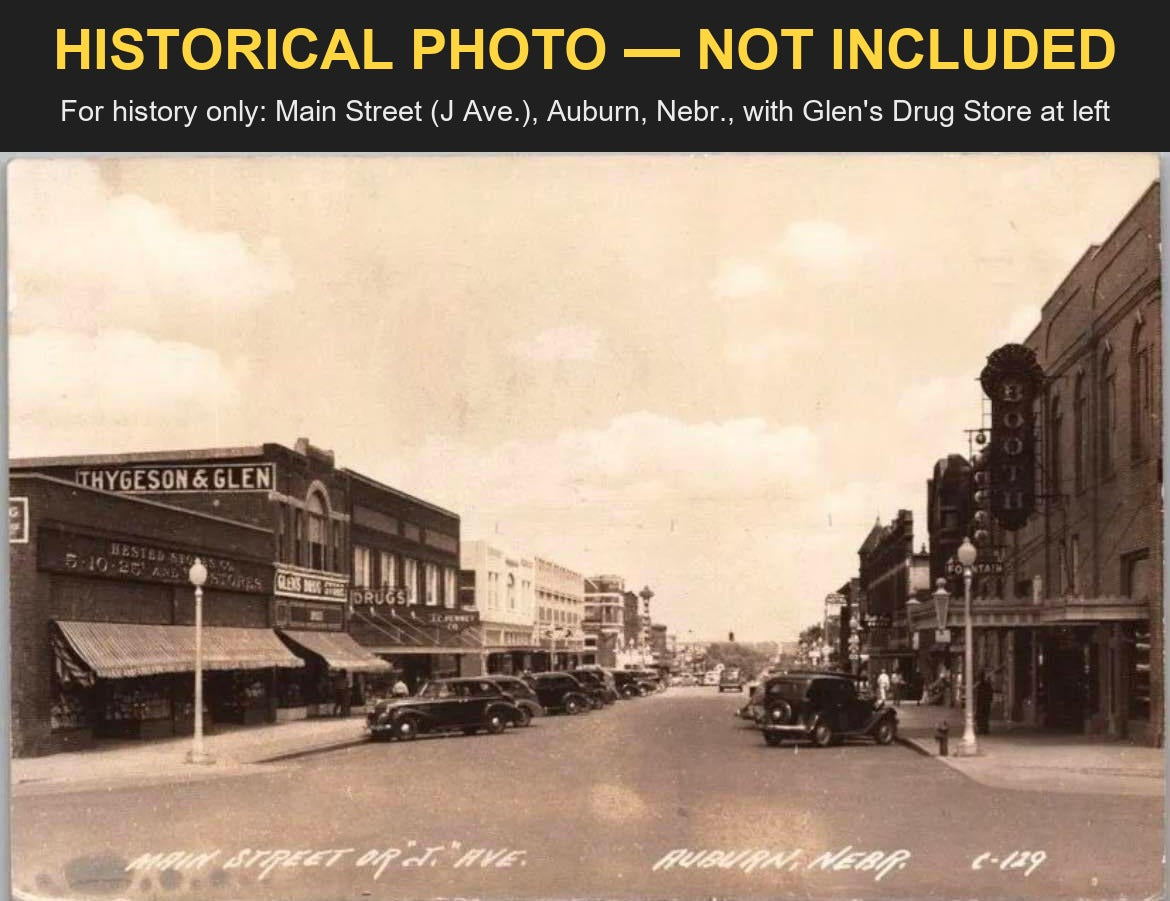 Historical photo, not included: a real-photo postcard of Main Street (J Ave.), Auburn, Nebraska, with the THYGESON & GLEN building and GLENS DRUG STORE sign at left, banded HISTORICAL PHOTO - NOT INCLUDED