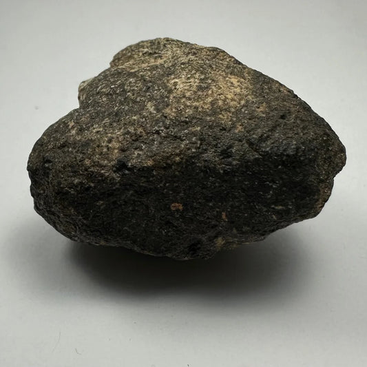 Rugged dark gray chondrite meteorite from South Sahara Desert, Morocco