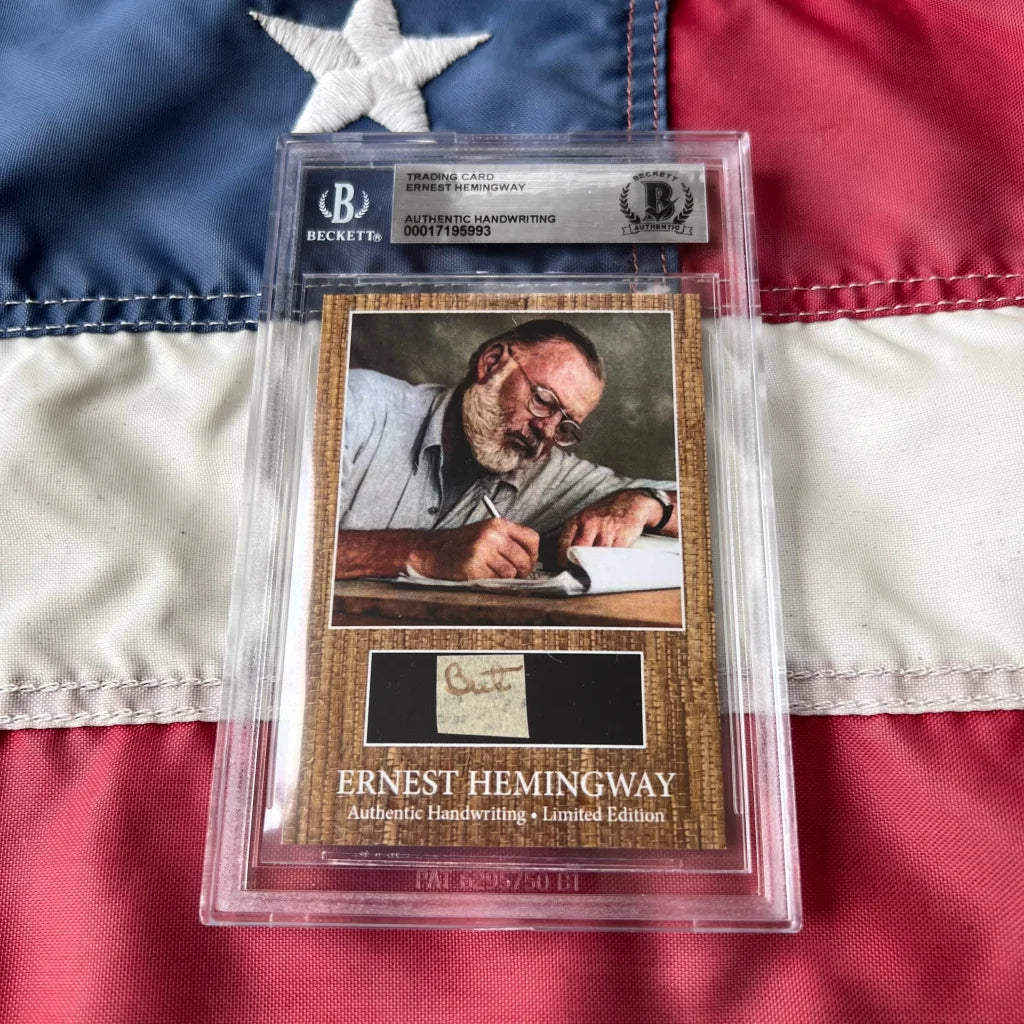 Authentic Ernest Hemingway handwriting graded cards encased in clear slab with black label on textured brown background