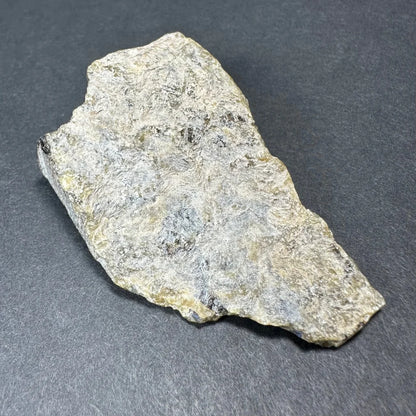 Rough silvery-gray Madagascar labradorite crystal specimen with yellow hints