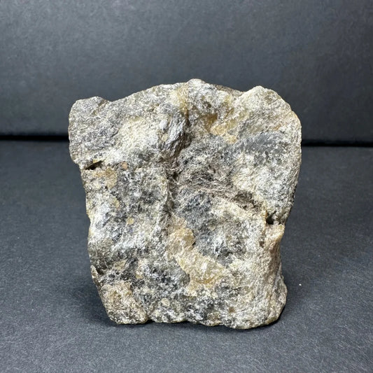 Rough gray Madagascar labradorite crystal with speckled tones