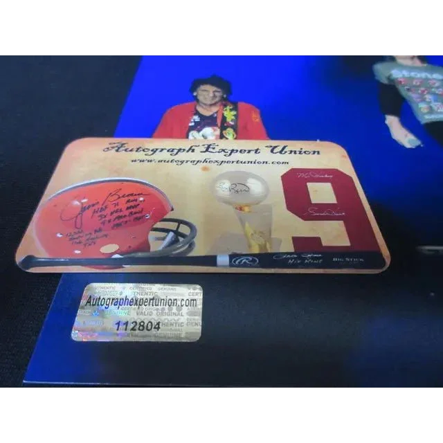 Memorabilia display with signed football helmet baseball bat and trophy featuring Mick Jagger