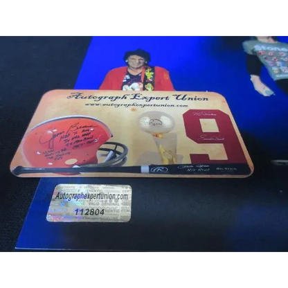 Memorabilia display with signed football helmet baseball bat and trophy featuring Mick Jagger