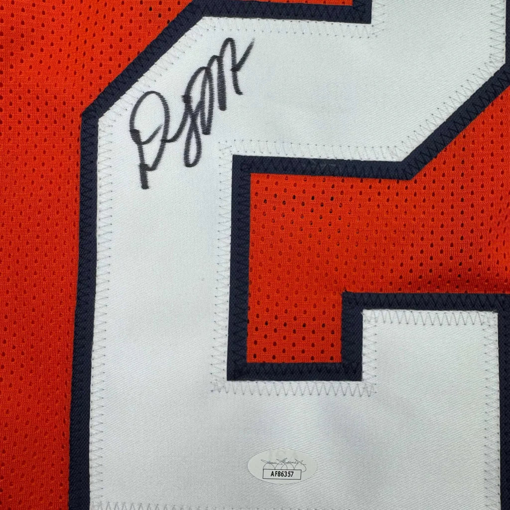 Autographed orange and white custom jersey from a professional sports league with authentication sticker