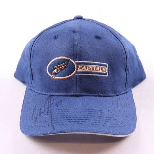 Blue Washington Capitals cap with a signature on the brim and the capitals logo