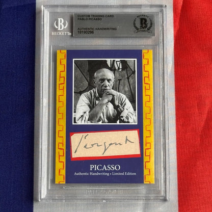 A framed authentic pablo picasso handwriting trading card with black and white portrait and beckett authentication holder