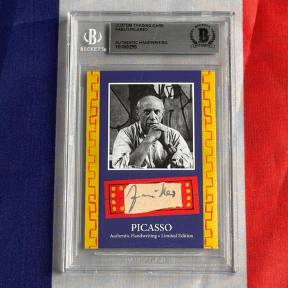A framed authentic pablo picasso handwriting trading card featuring a black and white portrait with beckett authentication services