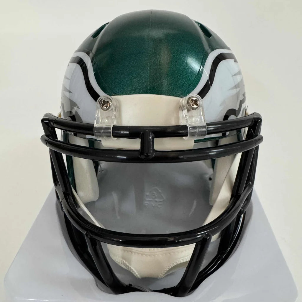 Philadelphia Eagles miniature football helmet with silver autograph on display