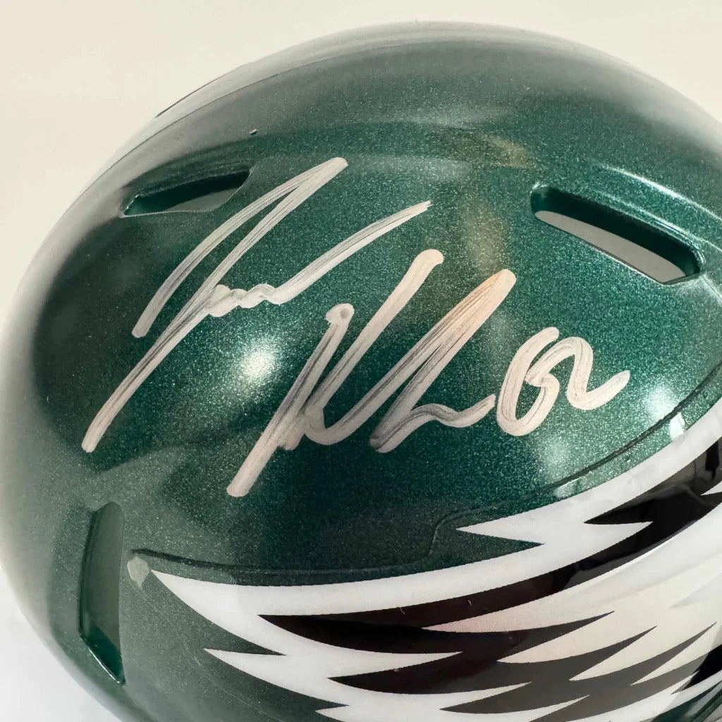 Green metallic Philadelphia Eagles mini helmet with eagle logo and silver autograph