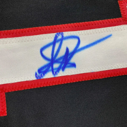 Black fabric with a white strip, red outline, and blue autograph on YAN Number 1 Jersey