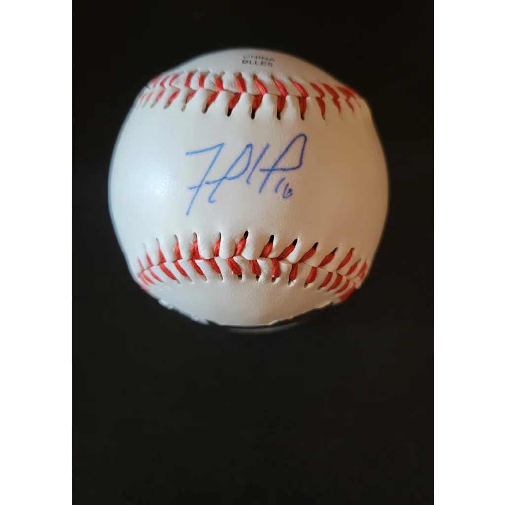 White baseball with red stitches and blue autograph, authentic York Yankees autographed Rawlings baseball