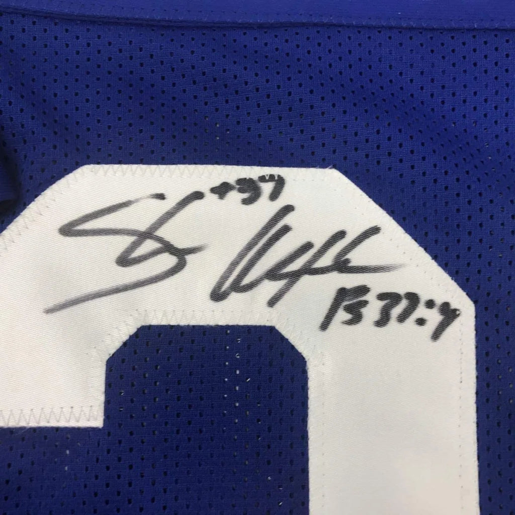 Autographed blue and white football jersey for wall display