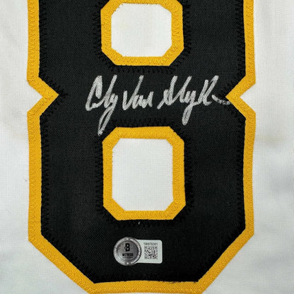 Autographed black and gold hockey jersey with number 8, in display