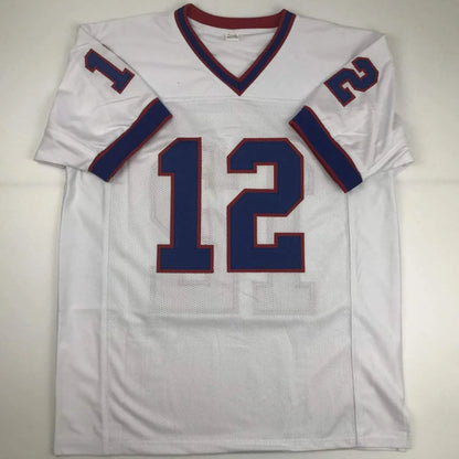 Autographed Kelly 12 custom football jersey with blue number 12 and red trim for pro sports