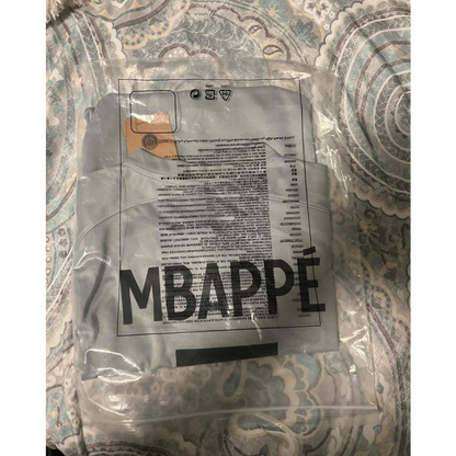Autographed Kylian Mbappe PSG jersey folded in plastic bag with MBAPPE print