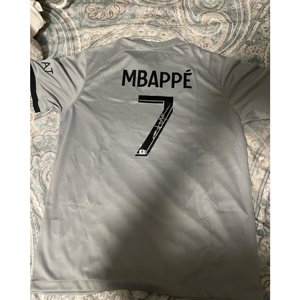 Gray kylian mbappe PSG jersey with autographed kylian mbappe and number 7 on back