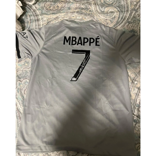 Gray kylian mbappe PSG jersey with autographed kylian mbappe and number 7 on back