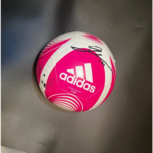Pink and white Adidas Starlancer Club soccer ball with a black signature, autographed Leo Messi