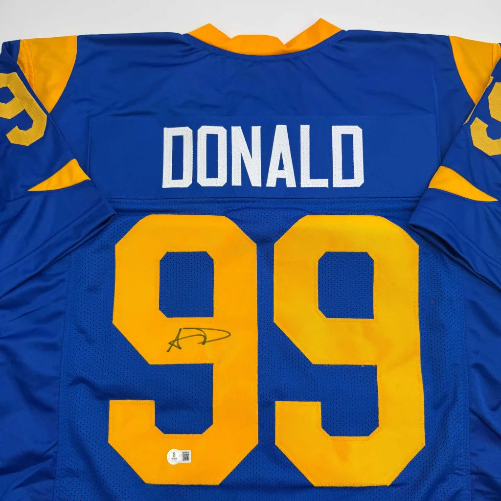 Blue and gold custom jersey with signature from a professional sports league