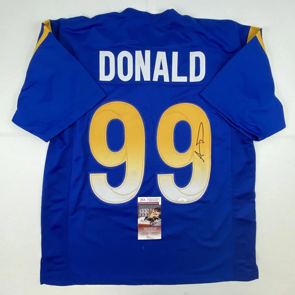 Back of a royal blue custom jersey with gold and white number 99 donald featuring an autograph for professional sports league use