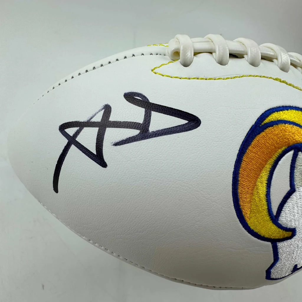 White Los Angeles Rams football with black autograph and third party authentication