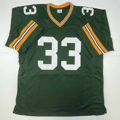 Autographed aaron jones green bay custom jersey in green with white number 33 and orange trim from professional sports league