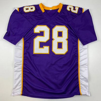 Purple and white football jersey with gold trim from Adrian Peterson Signed Vikings jersey in professional sports league