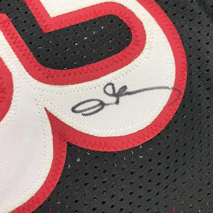 Autographed black custom jersey from professional sports league with red and white number