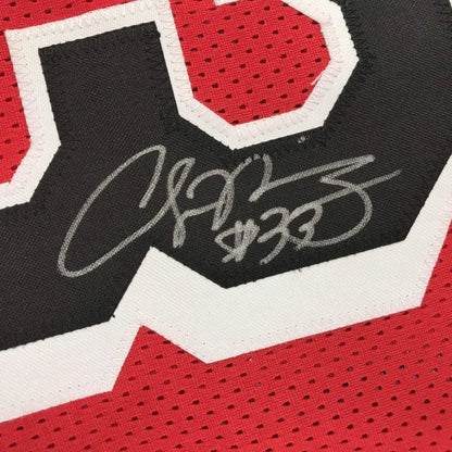 Autographed red custom jersey from professional sports league featuring black and white numbers