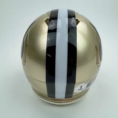 Gold football helmet with black and white stripes for Authentic New Orleans Saints Mini Helmet with third party authentication