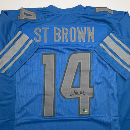 Autographed Amon-Ra St. Brown Detroit Blue Football Jersey Beckett BAS COA | Certified Authentic Signed Memorabilia | vintageantiquesgifts.com