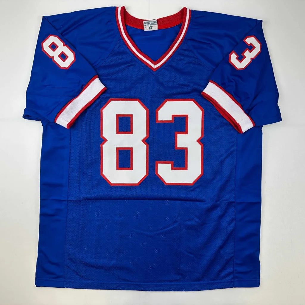 Blue football jersey with white and red trim, signed REED 83 from professional sports league