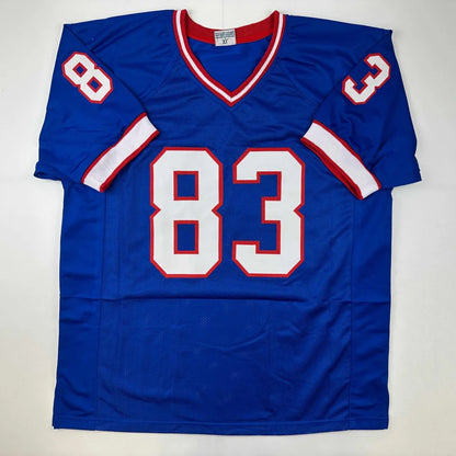 Blue football jersey with white and red trim, signed REED 83 from professional sports league