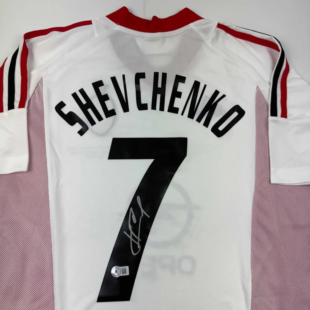 Back view of autographed andriy shevchenko ac milan white soccer jersey with black name number and red collar stripes