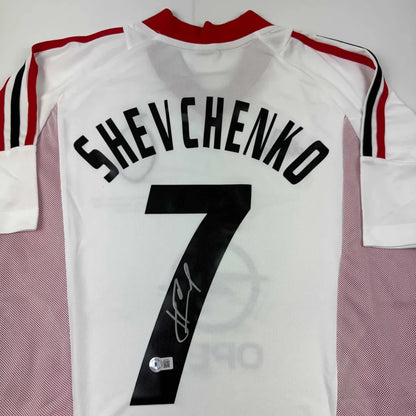 Back view of autographed andriy shevchenko ac milan white soccer jersey with black name number and red collar stripes