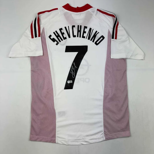 Back side of autographed andriy shevchenko ac milan white soccer jersey with red and black trim and number 7 in black