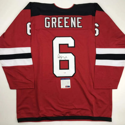 Autographed red hockey jersey with GREENE and number 6 from professional sports league