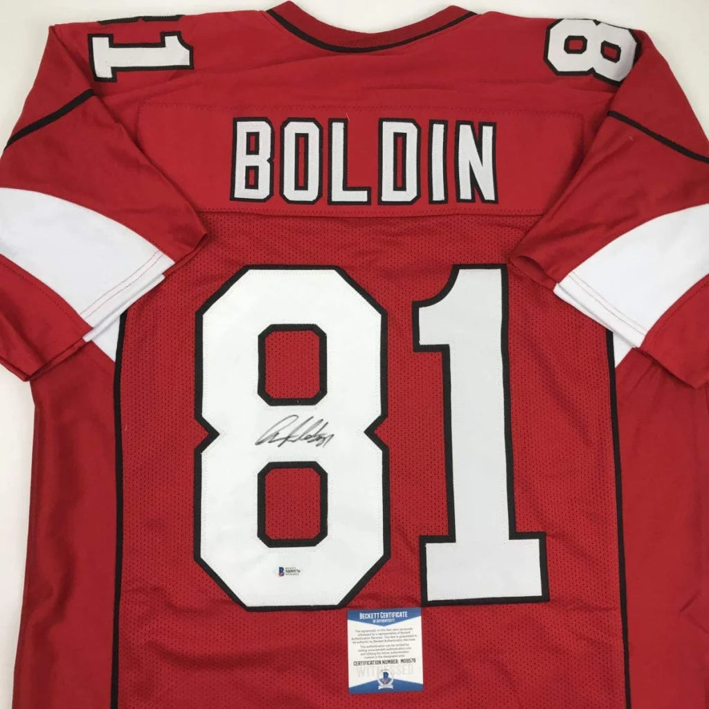 Back of autographed red anquan boldin football jersey with white number 81 and black trim from professional sports league