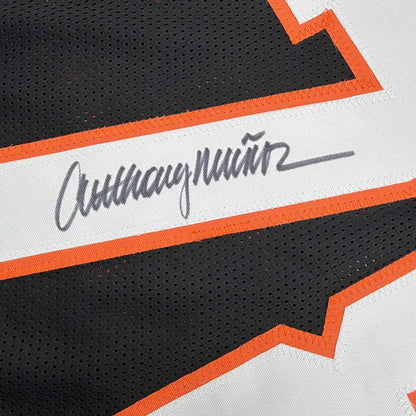 Autographed Anthony Munoz custom jersey in black and orange mesh with white stripe and gray cursive script, professional sports NFL item