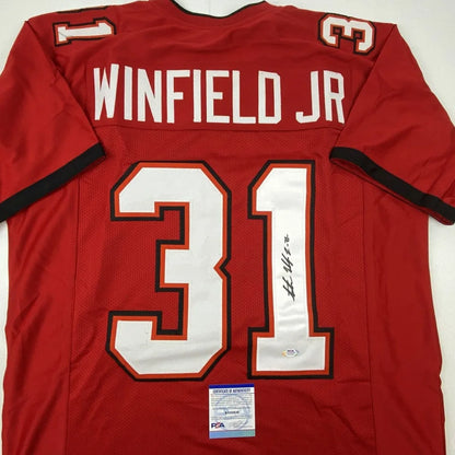 Back side of red autographed Antoine Winfield Jr Tampa Bay custom jersey with white and black trim from professional sports league