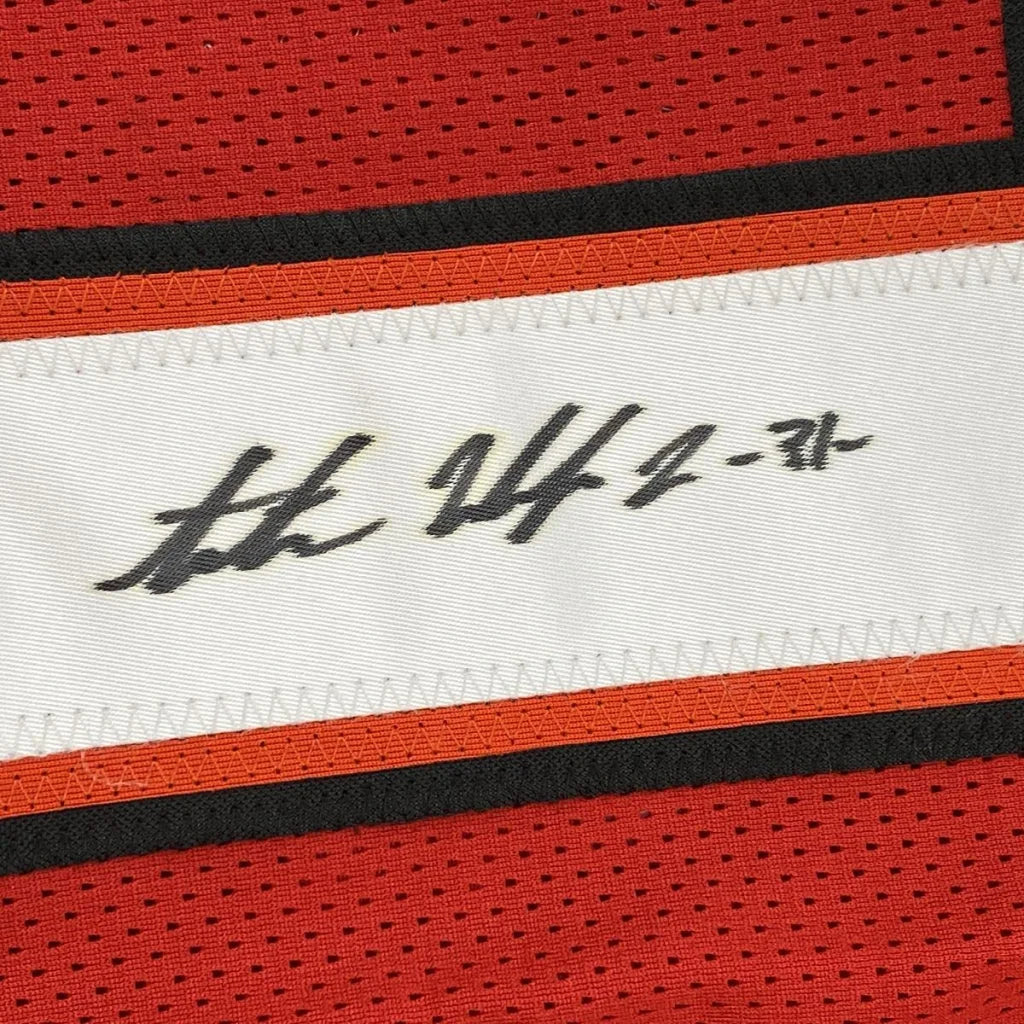 Red and black mesh custom athletic jersey with white handwritten label autographed by Antoine Winfield Jr from professional sports league