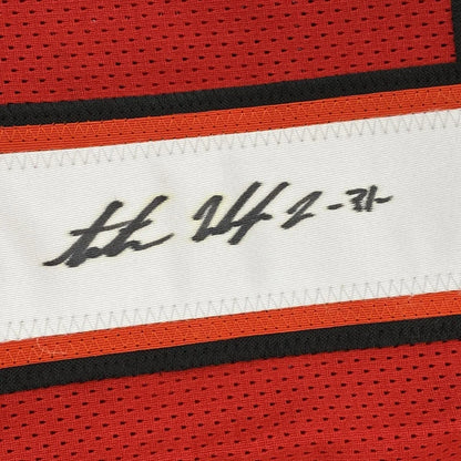 Red and black mesh custom athletic jersey with white handwritten label autographed by Antoine Winfield Jr from professional sports league