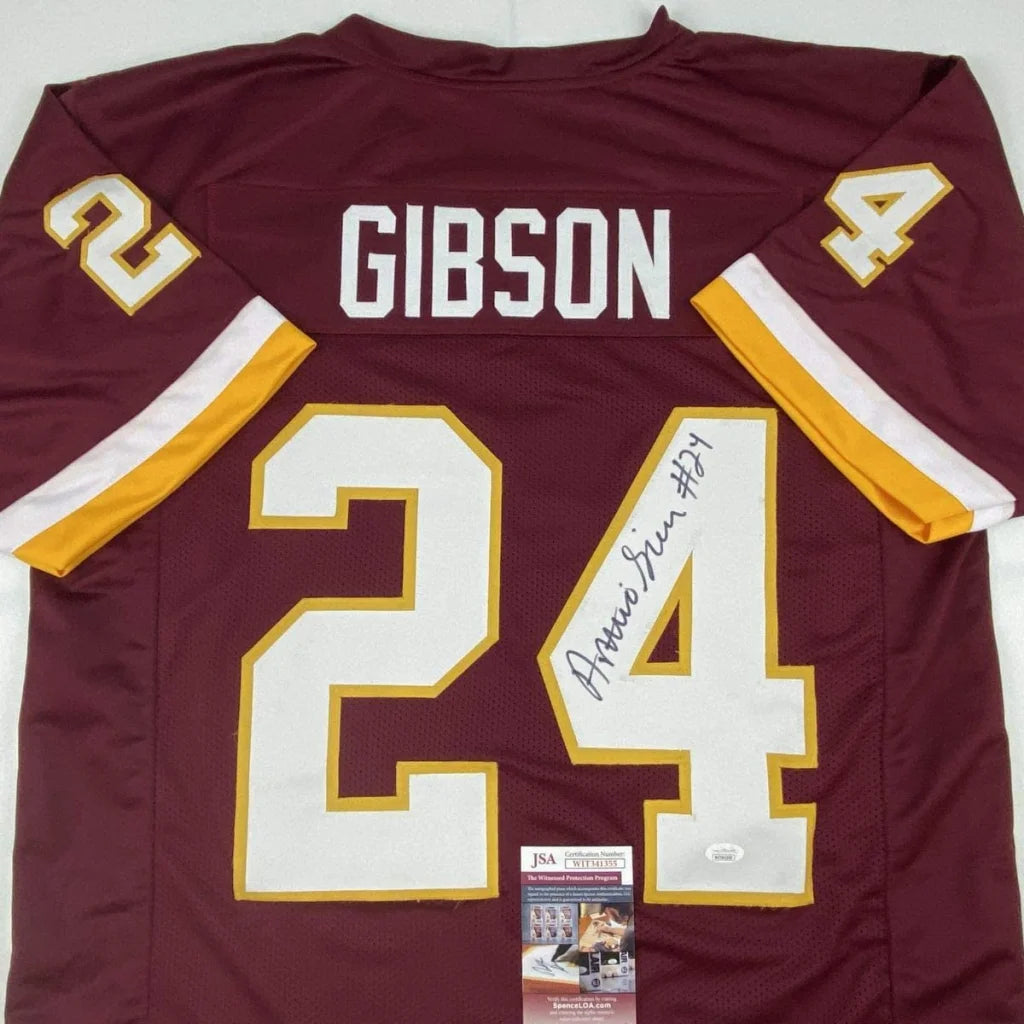 Back side of a maroon washington football jersey with white and gold numerals signed by antonio gibson, a professional sports custom jersey