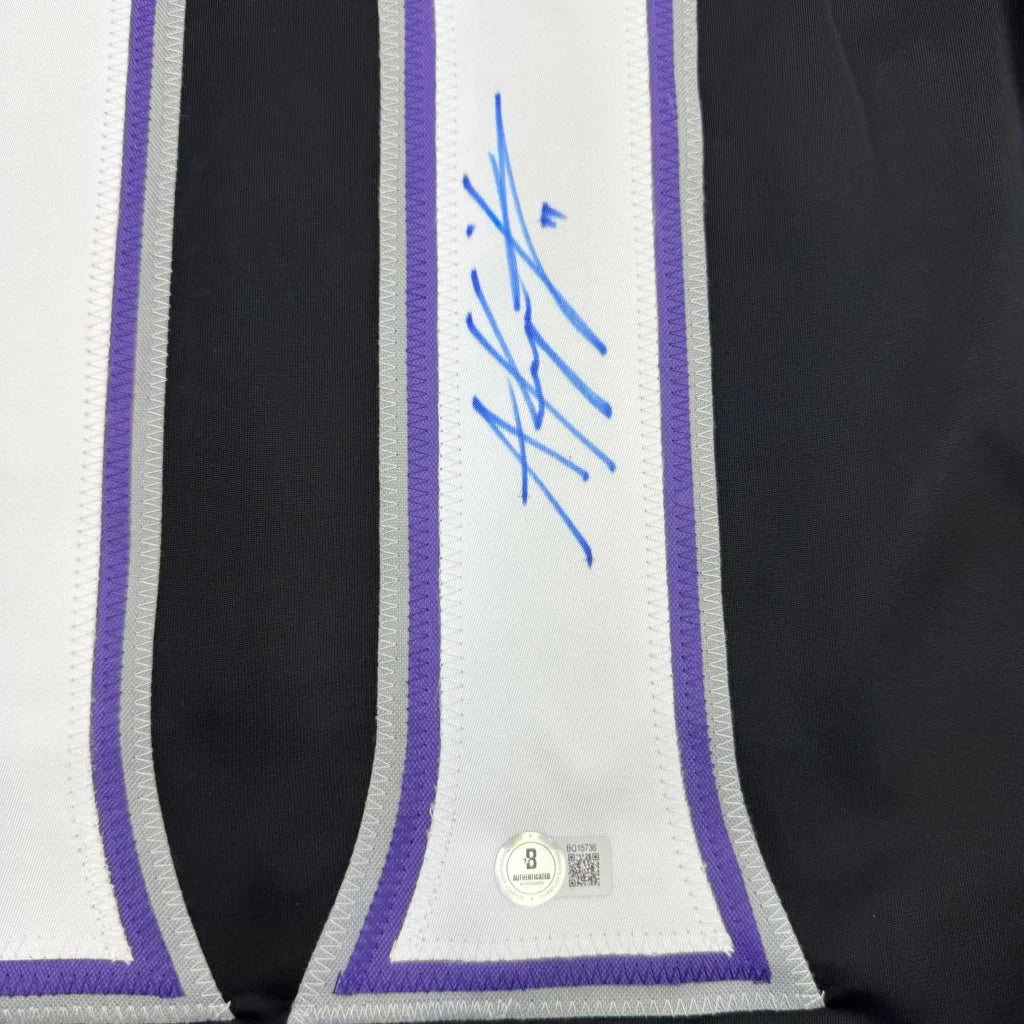 Black custom jersey with white, purple, silver trim signed in blue ink, authentic hologram for professional sports fans