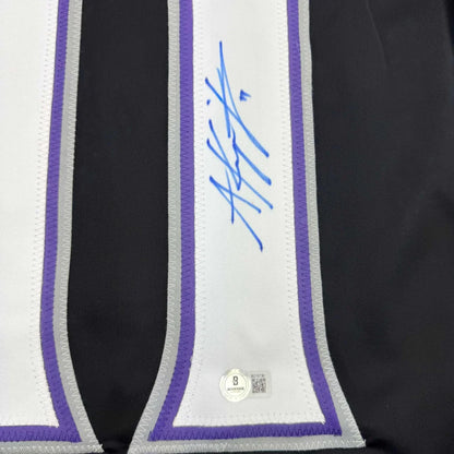 Black custom jersey with white, purple, silver trim signed in blue ink, authentic hologram for professional sports fans