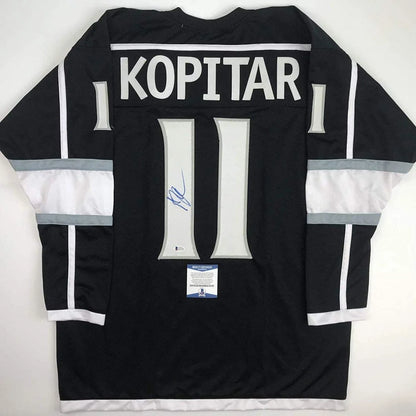 Black hockey jersey with white gray accents, signed Anze Kopitar memorabilia